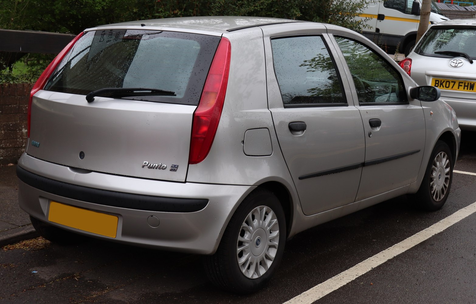 Silver 5-door hatchback with tall vertical tail lights and side view showing doors and windows