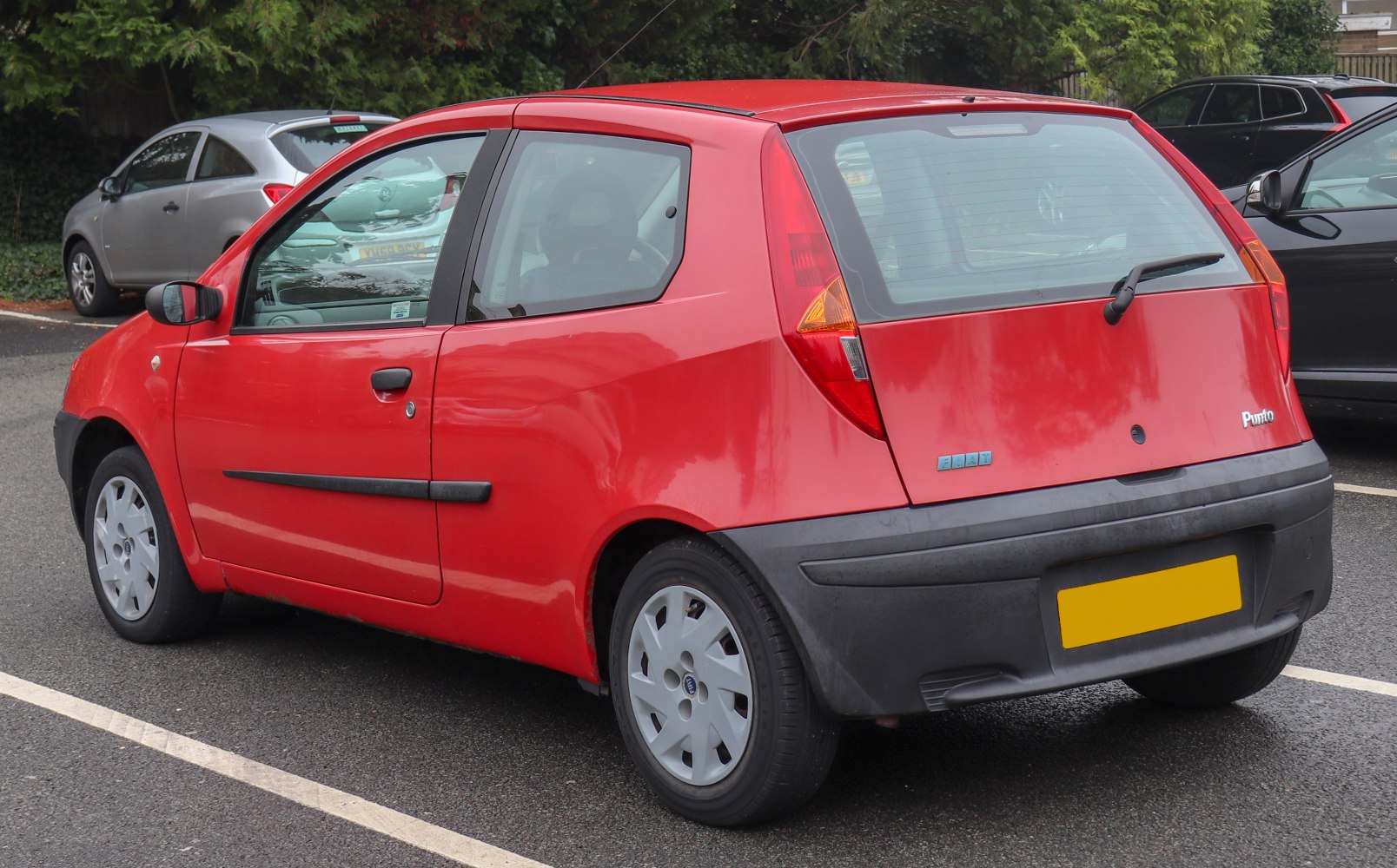 Red 3-door hatchback with vertical rear lights and simple alloy wheels