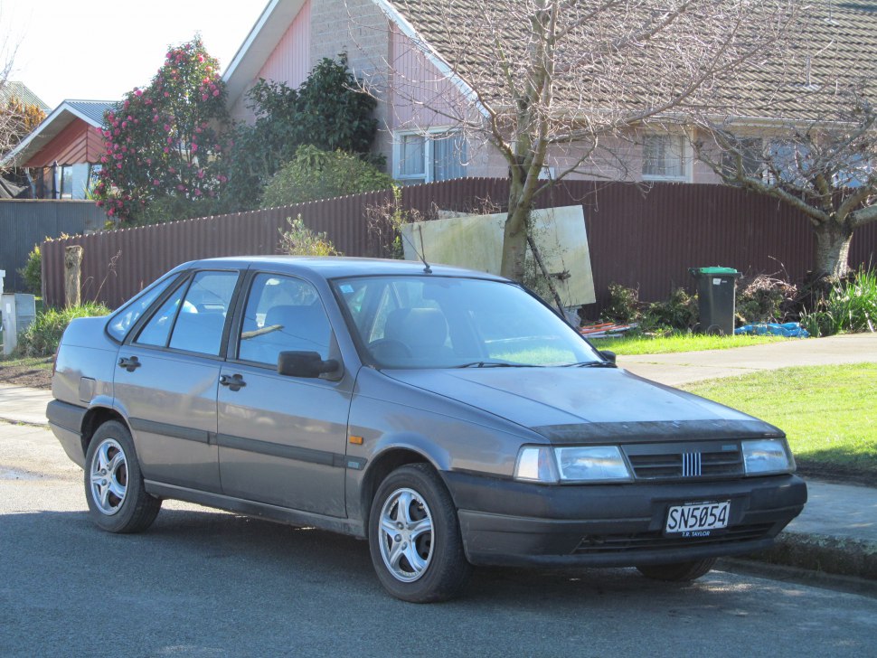 Classic early 90s four-door sedan with vintage European styling.