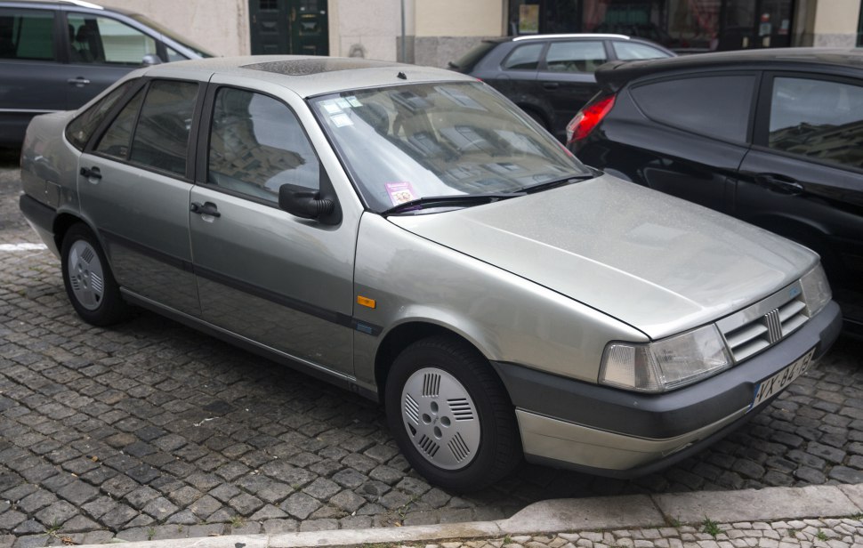 Boxy compact sedan with rectangular headlights and simple wheel covers
