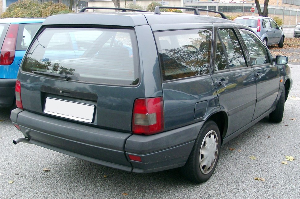 Rear view of a classic 1990s station wagon with distinct taillights and hatchback design