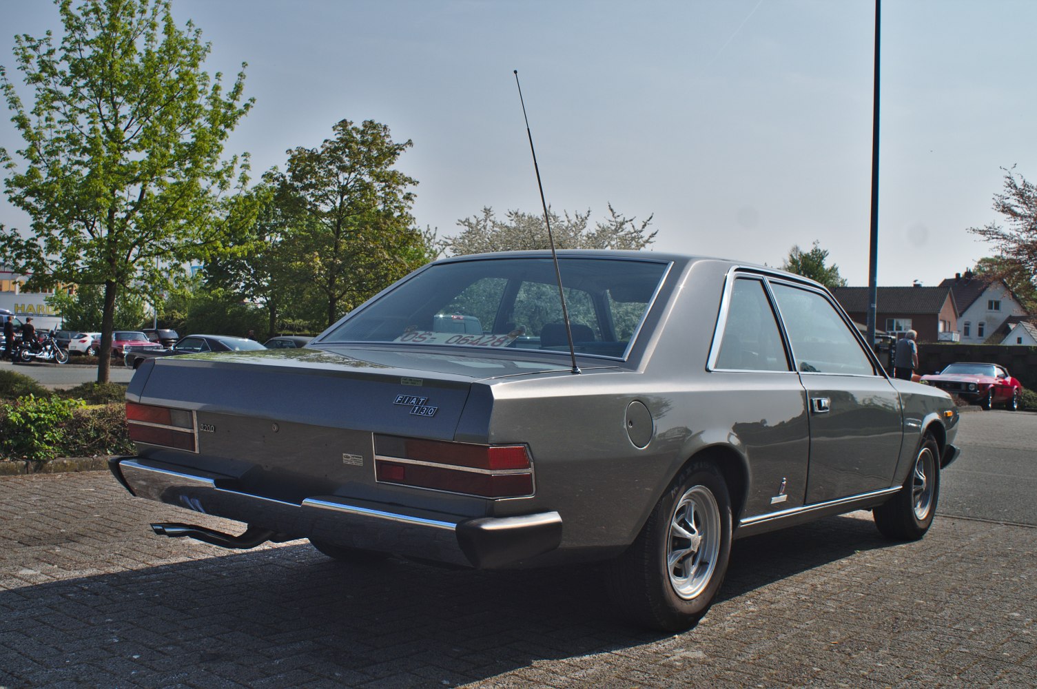 Rear view of a vintage sedan with chrome bumper and antenna