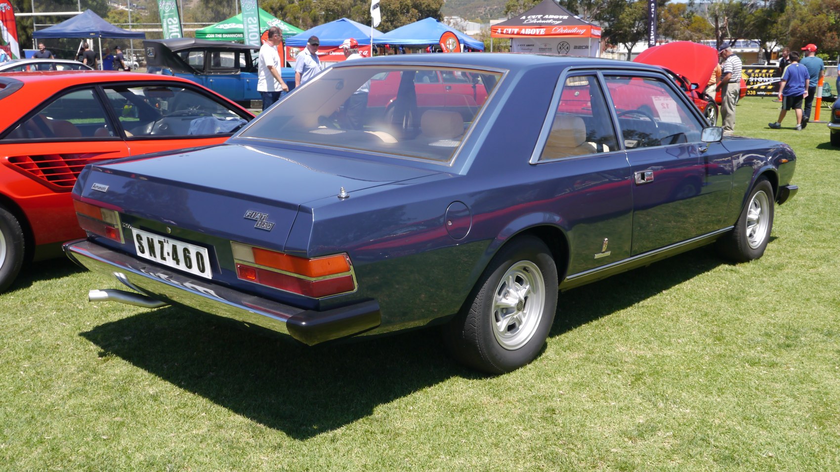 Rear view of a vintage two-door coupe with chrome bumper and angular design.
