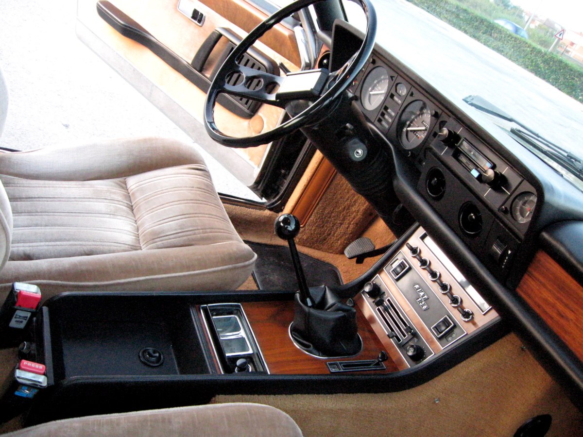 Classic vintage car interior with wood paneling and manual gear shift