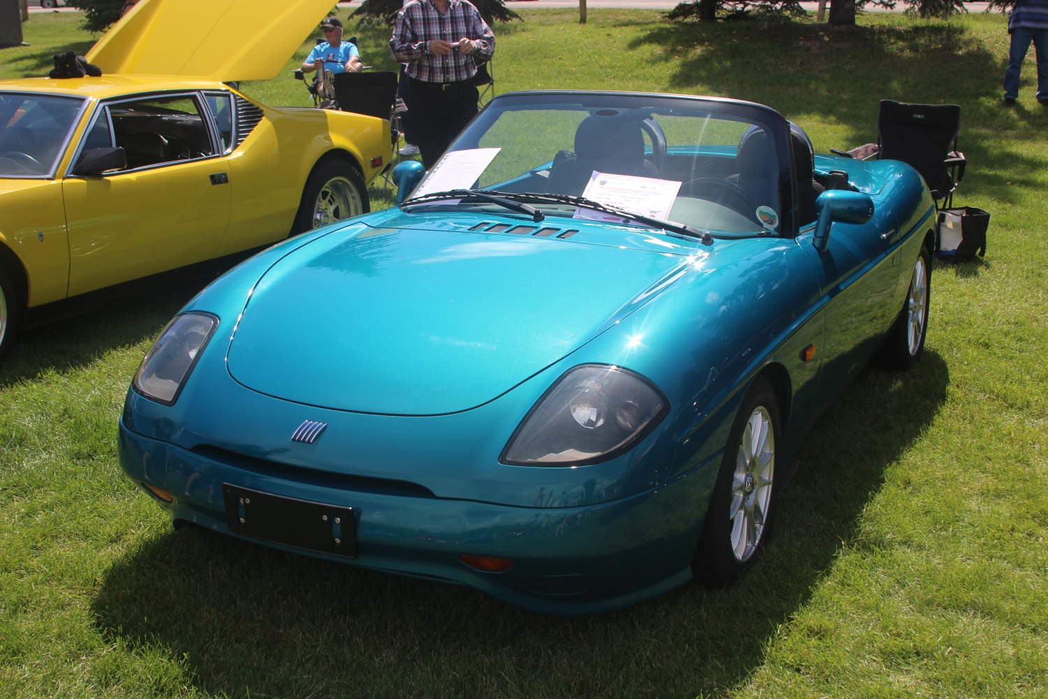 Blue convertible roadster with sleek aerodynamic design and sporty features.