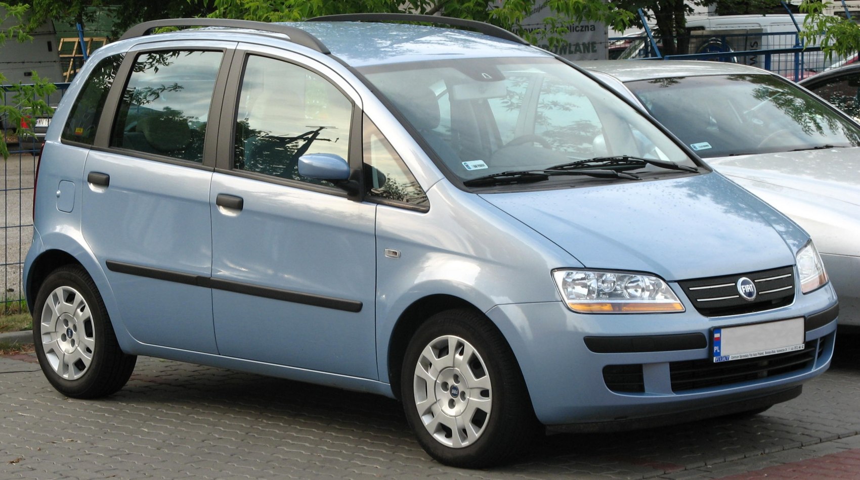 Light blue 5-door hatchback with roof rails and black side trim.