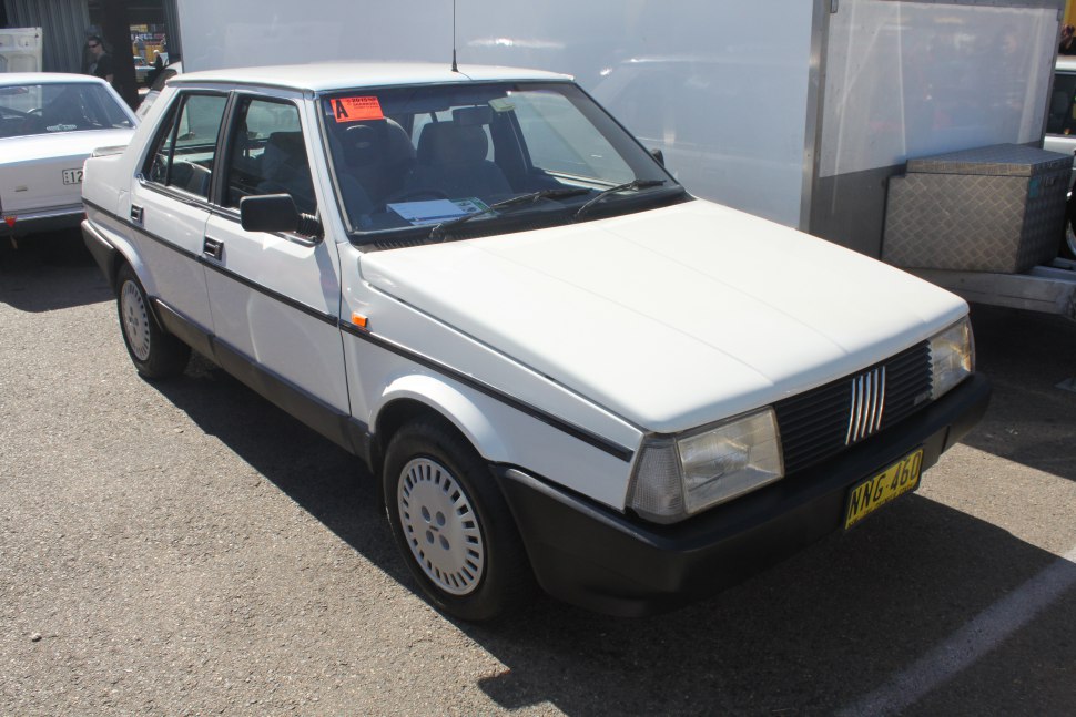 White sedan with angular 1980s design and distinctive front grille