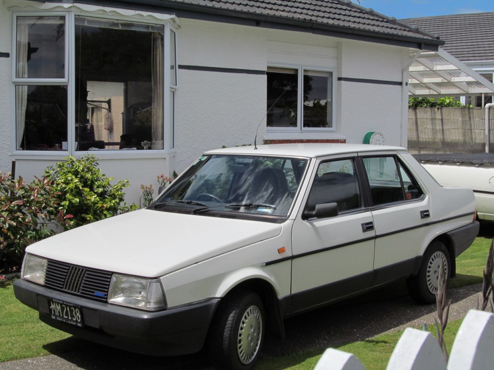 Boxy four-door sedan with black trim and traditional 1980s styling.