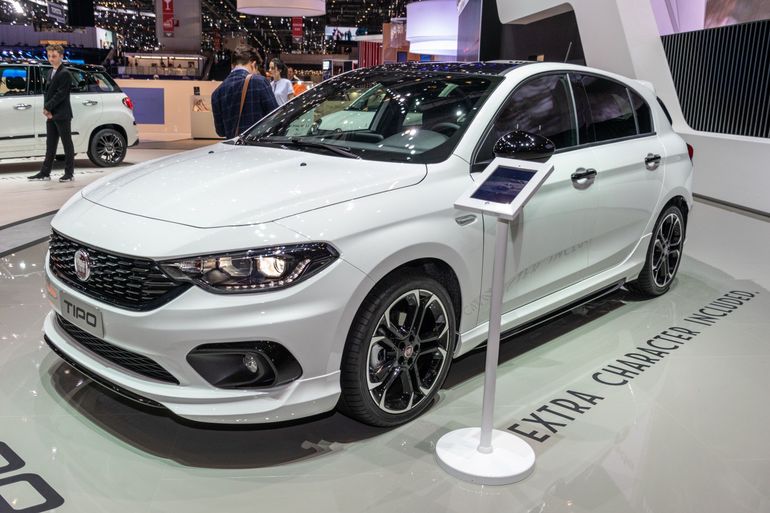 Front-side view of white hatchback with sporty headlights and alloy wheels