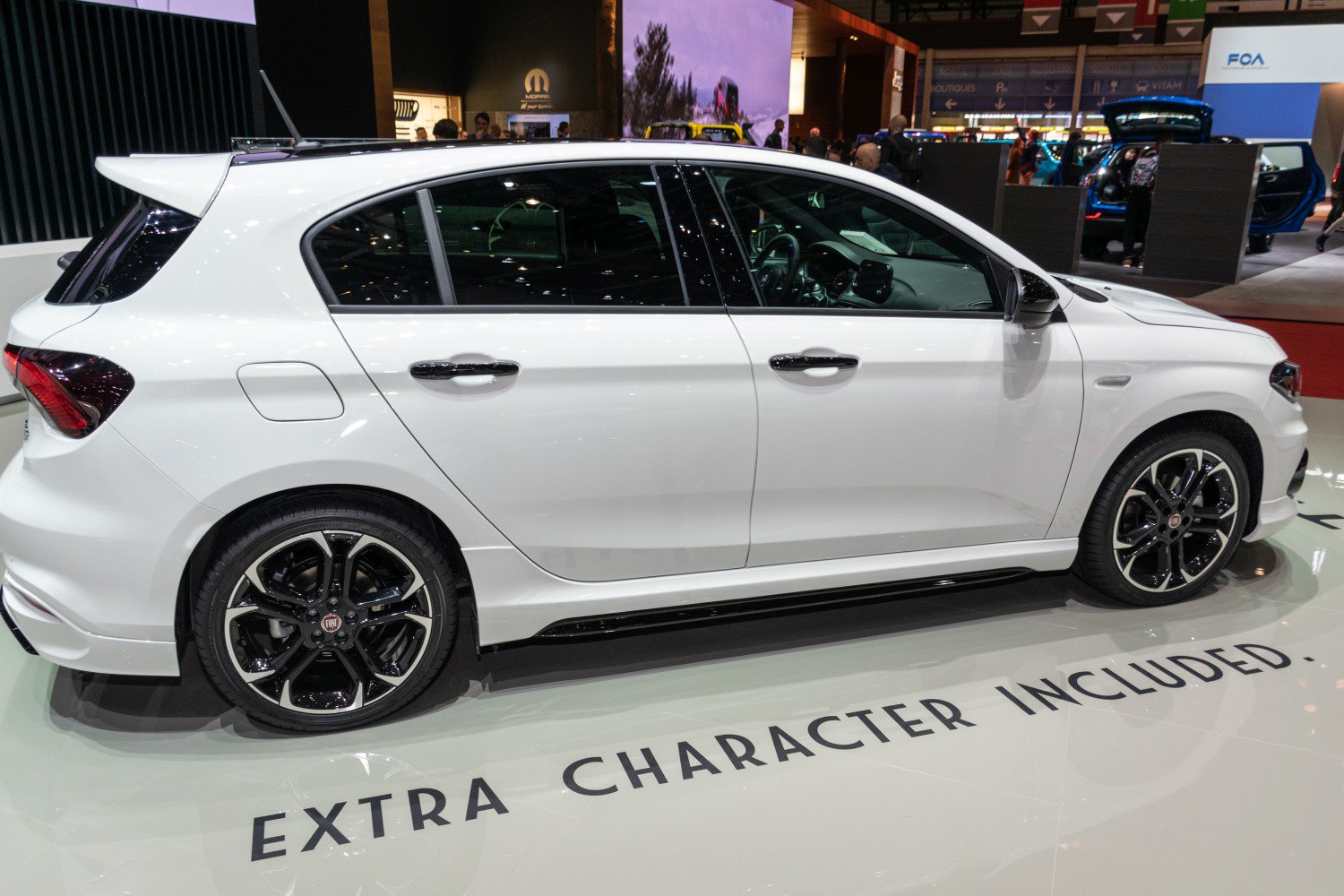 Side profile of a hatchback with sporty alloy wheels and a rear spoiler