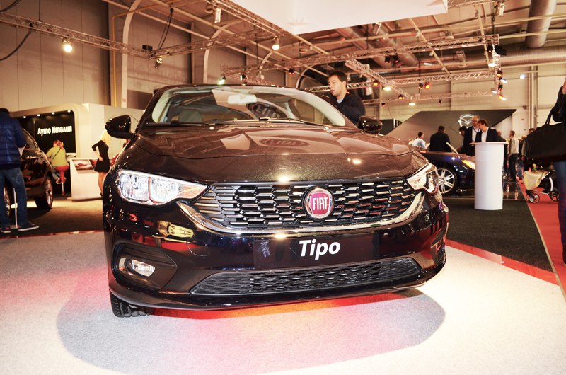 Close-up front view with sleek headlights and distinctive grille