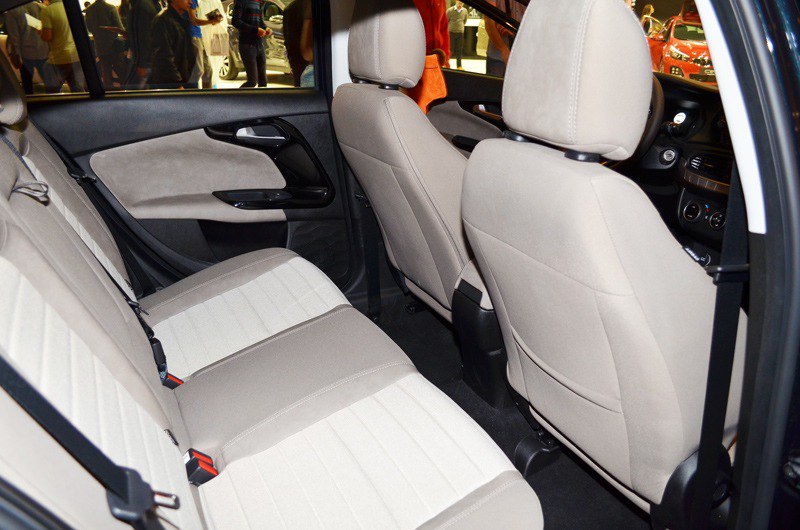 Beige rear seats and door panel with fabric upholstery.