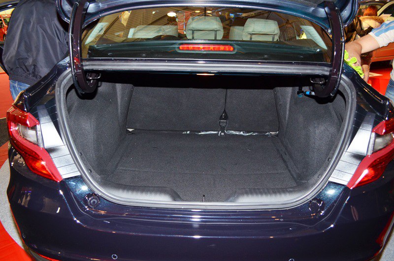 Large, well-lit trunk interior with folded rear seat access