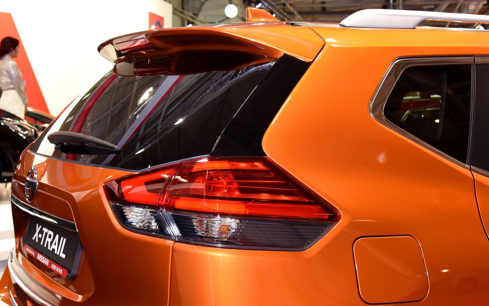 Rear tail light and tailgate with rear window wiper in orange vehicle
