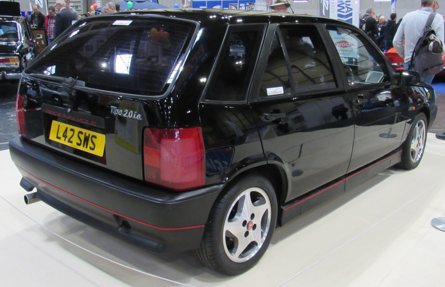 Black hatchback rear side with alloy wheels and tail lights
