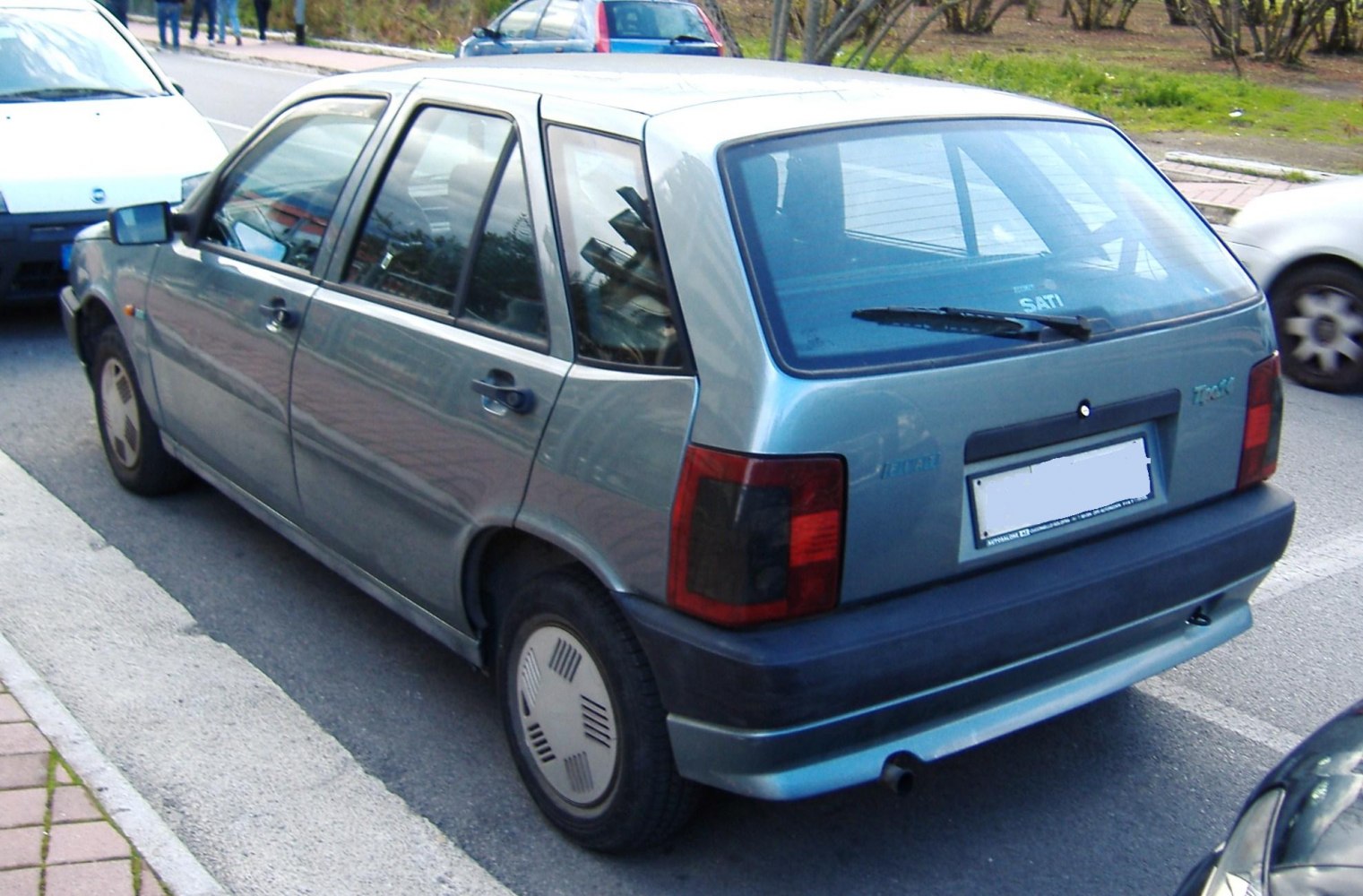 Rear side view of classic hatchback with angular design and rear wiper