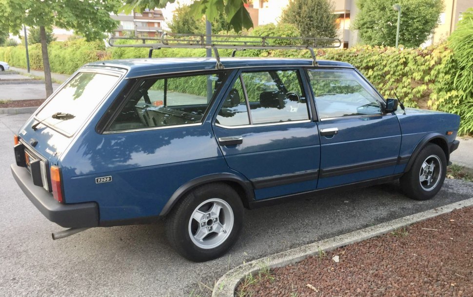 Vintage panoramic station wagon with roof rack, side profile