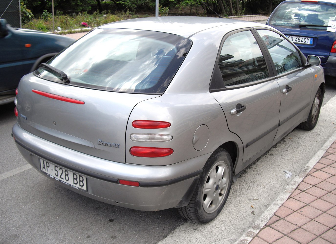 Silver hatchback rear with rear window wiper and oval tail lights