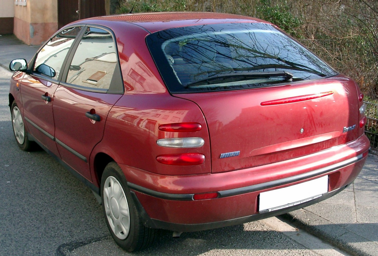 Compact hatchback rear with rounded tail lights and rear wiper