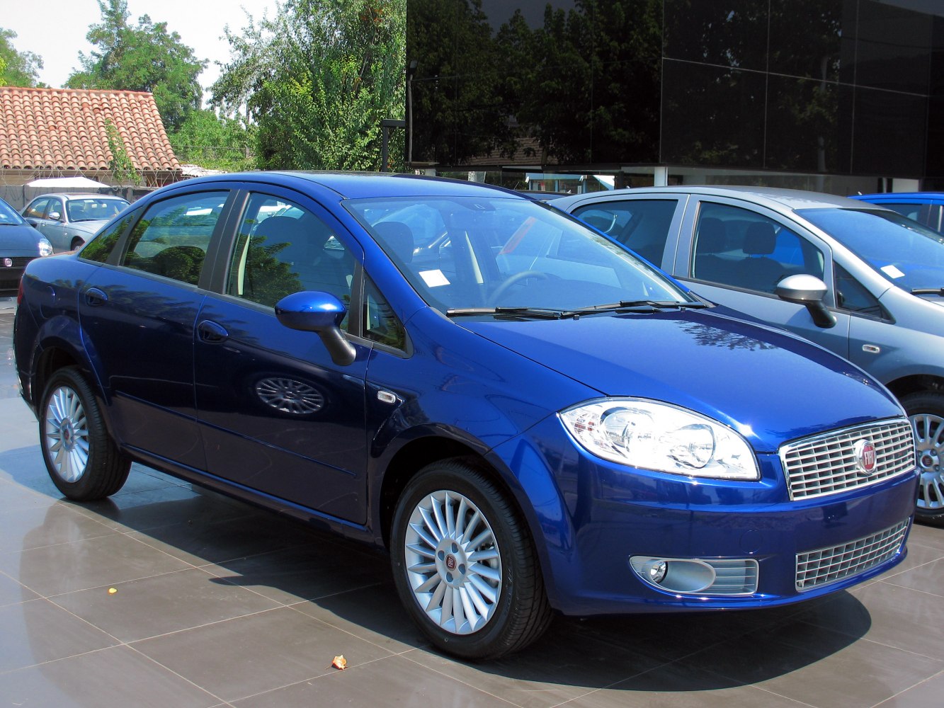 Blue sedan with alloy wheels and distinctive front headlights
