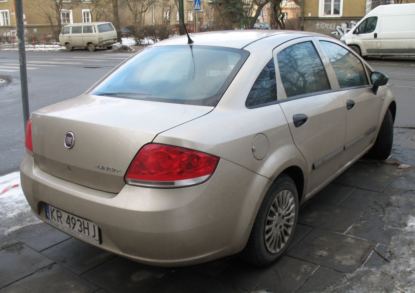 Four-door sedan rear with red taillights and tinted windows