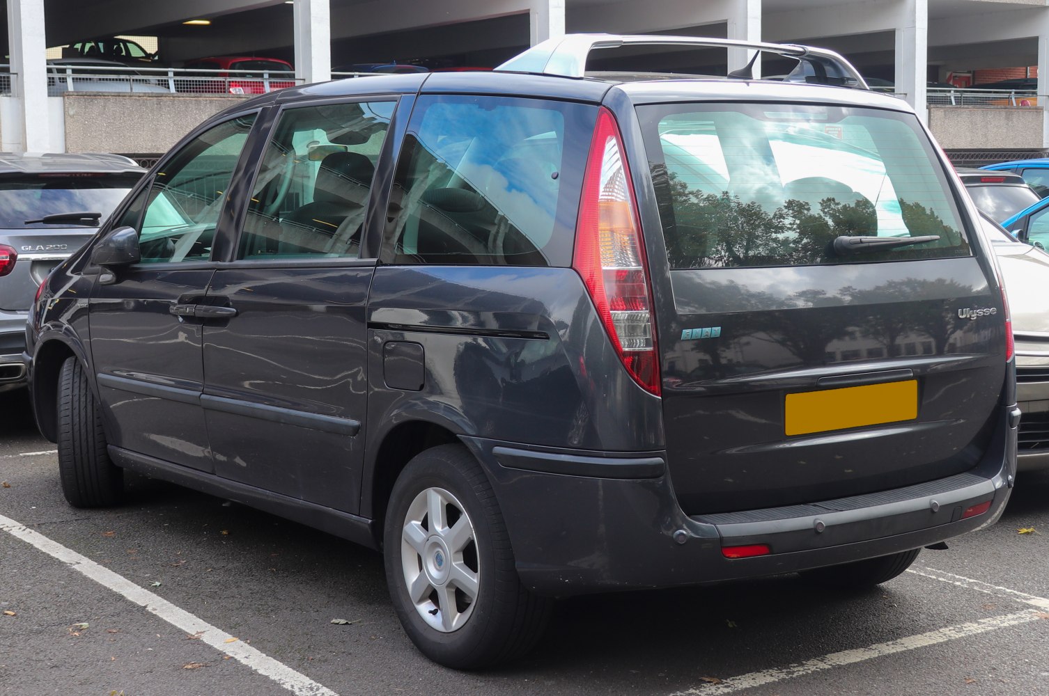 Rear and side view of minivan with vertical tail lights and large windows