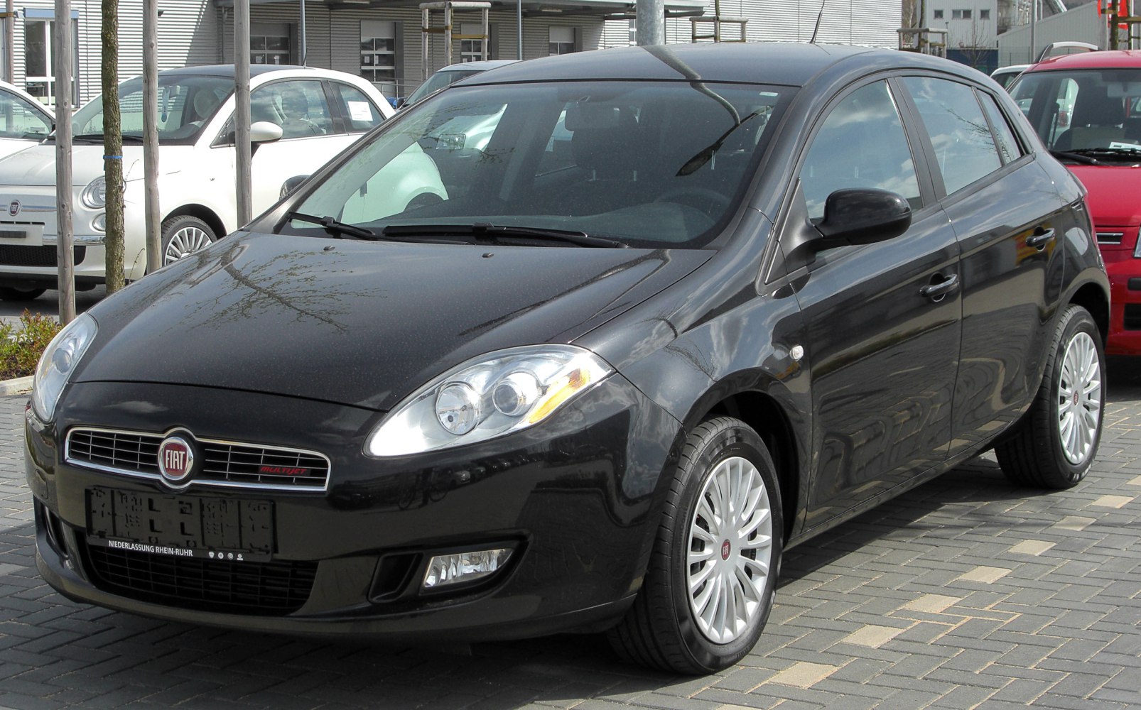 Black hatchback with sleek headlights and alloy wheels