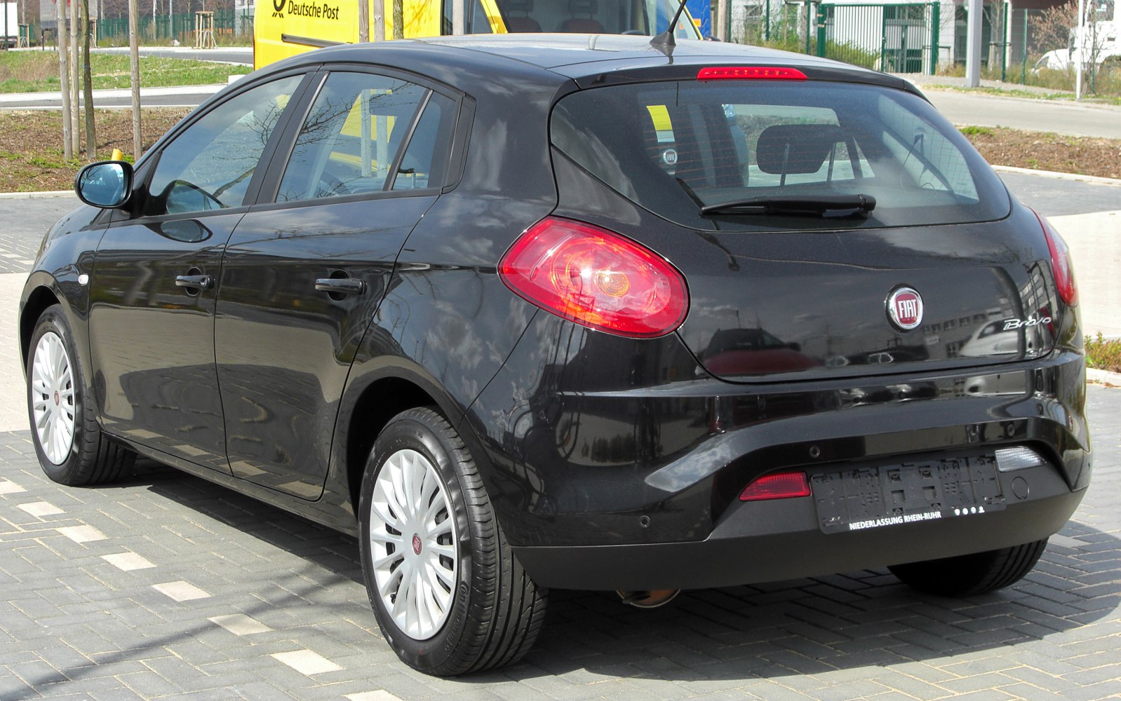 Rear and side view of black hatchback with distinct taillights.