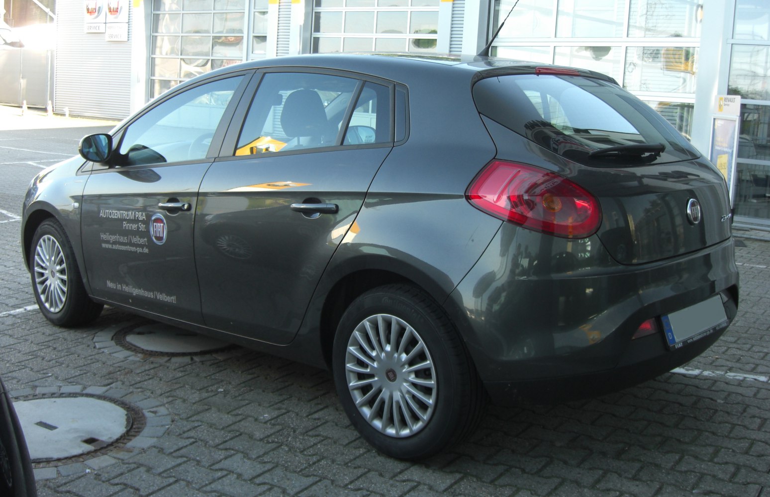 Rear-side view with distinct tail lights and detailed wheel rims.