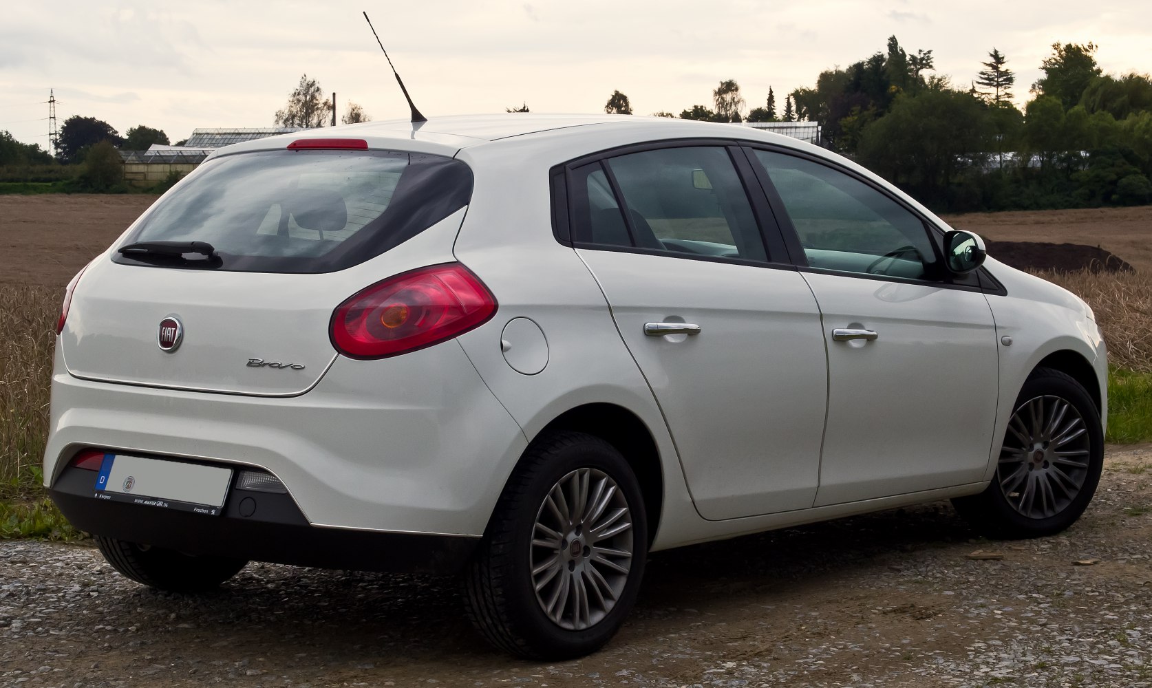 White hatchback rear side with taillights and alloy wheels