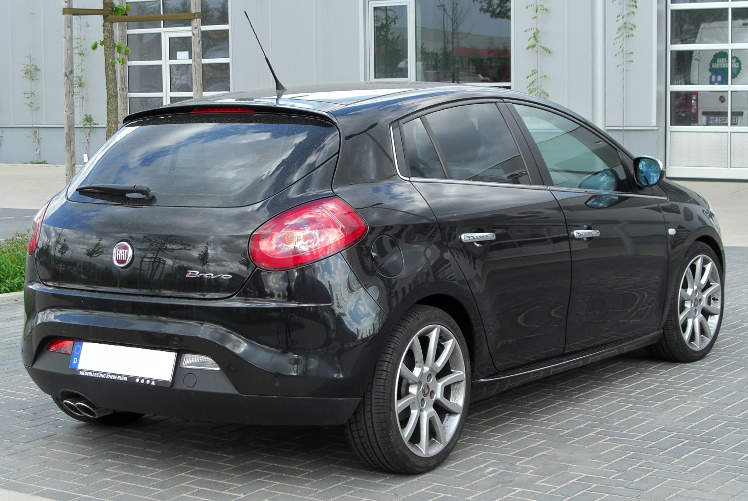Rear side view of a hatchback with distinctive taillights and alloy wheels