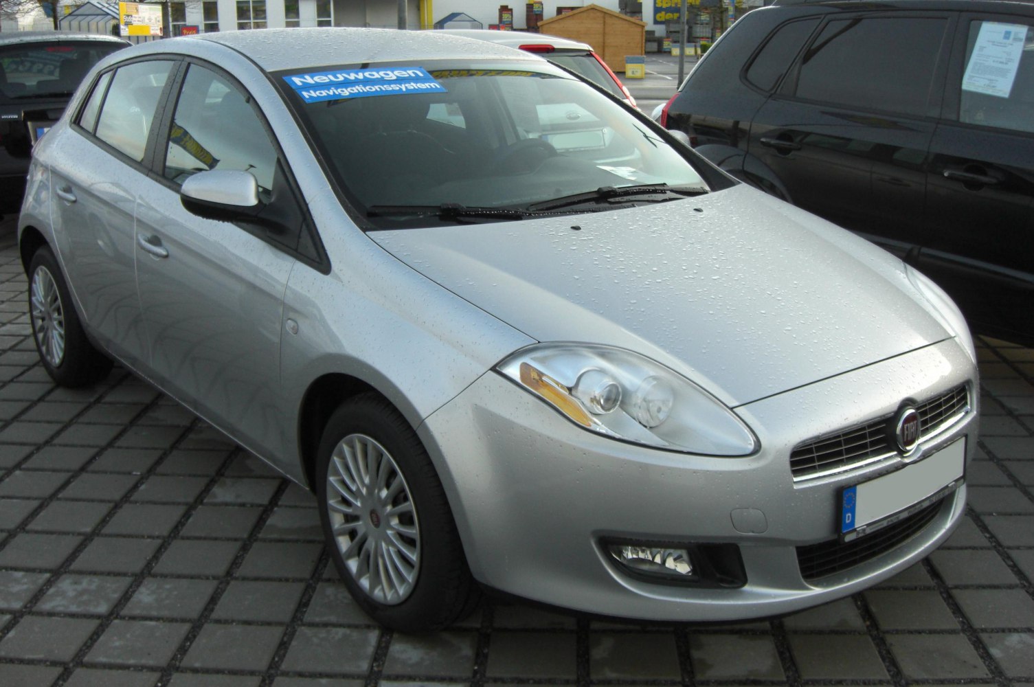 Front-side view of silver hatchback with distinct headlamps and alloy wheels