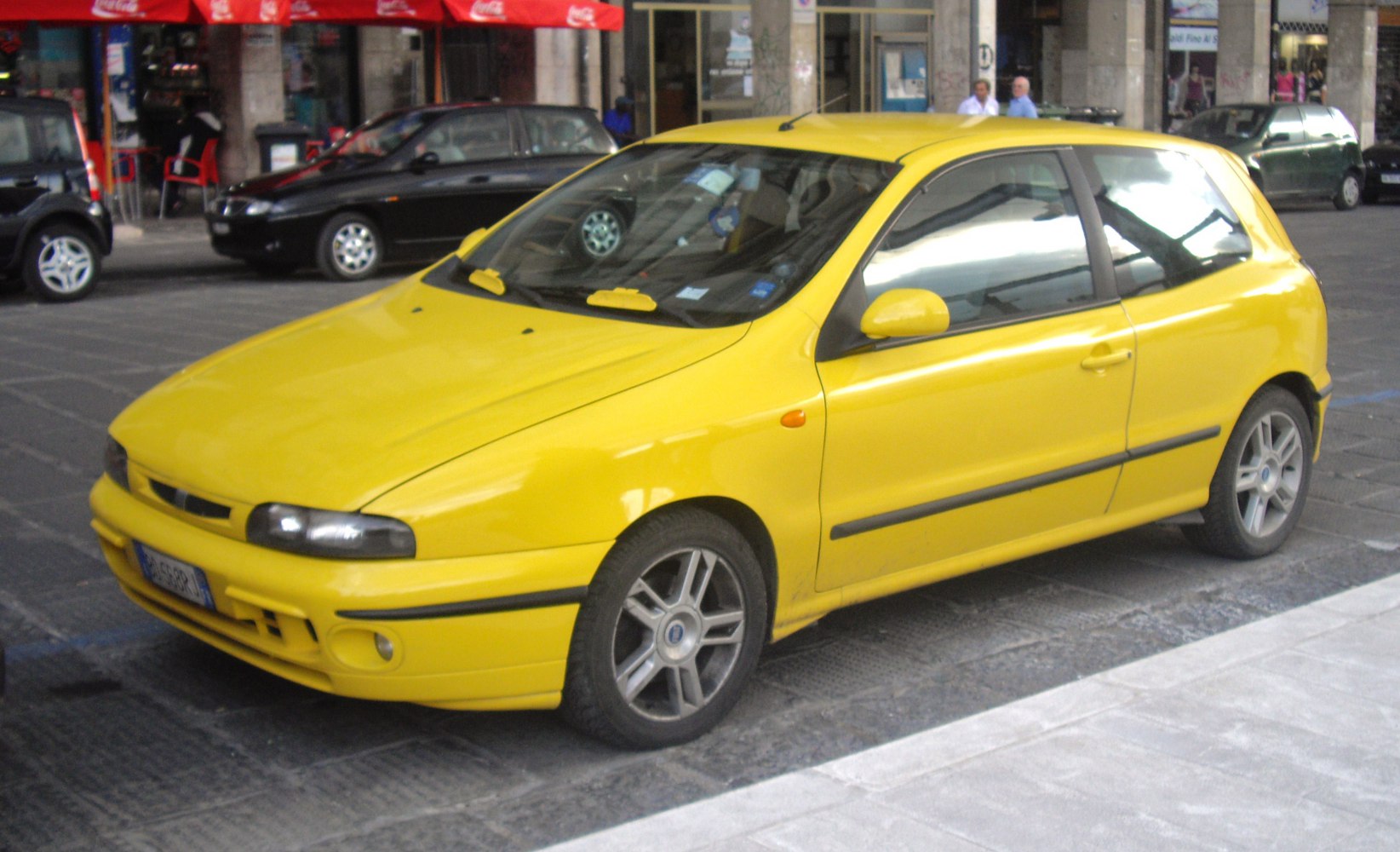 yellow compact hatchback with sporty alloy wheels and black trim