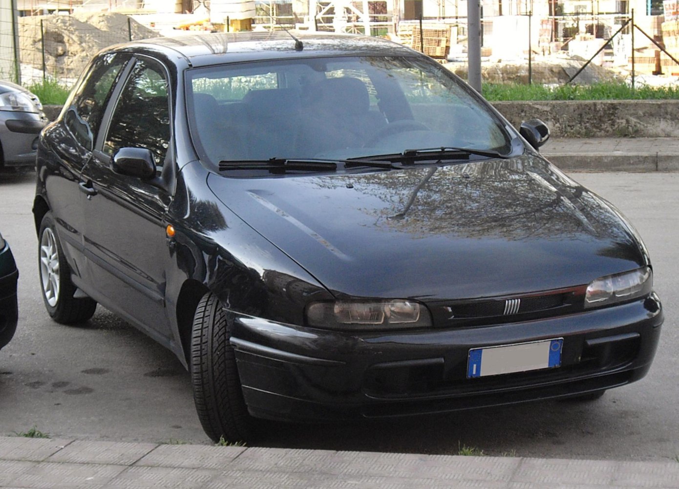 Front view of a black compact hatchback with sleek headlights and bumper
