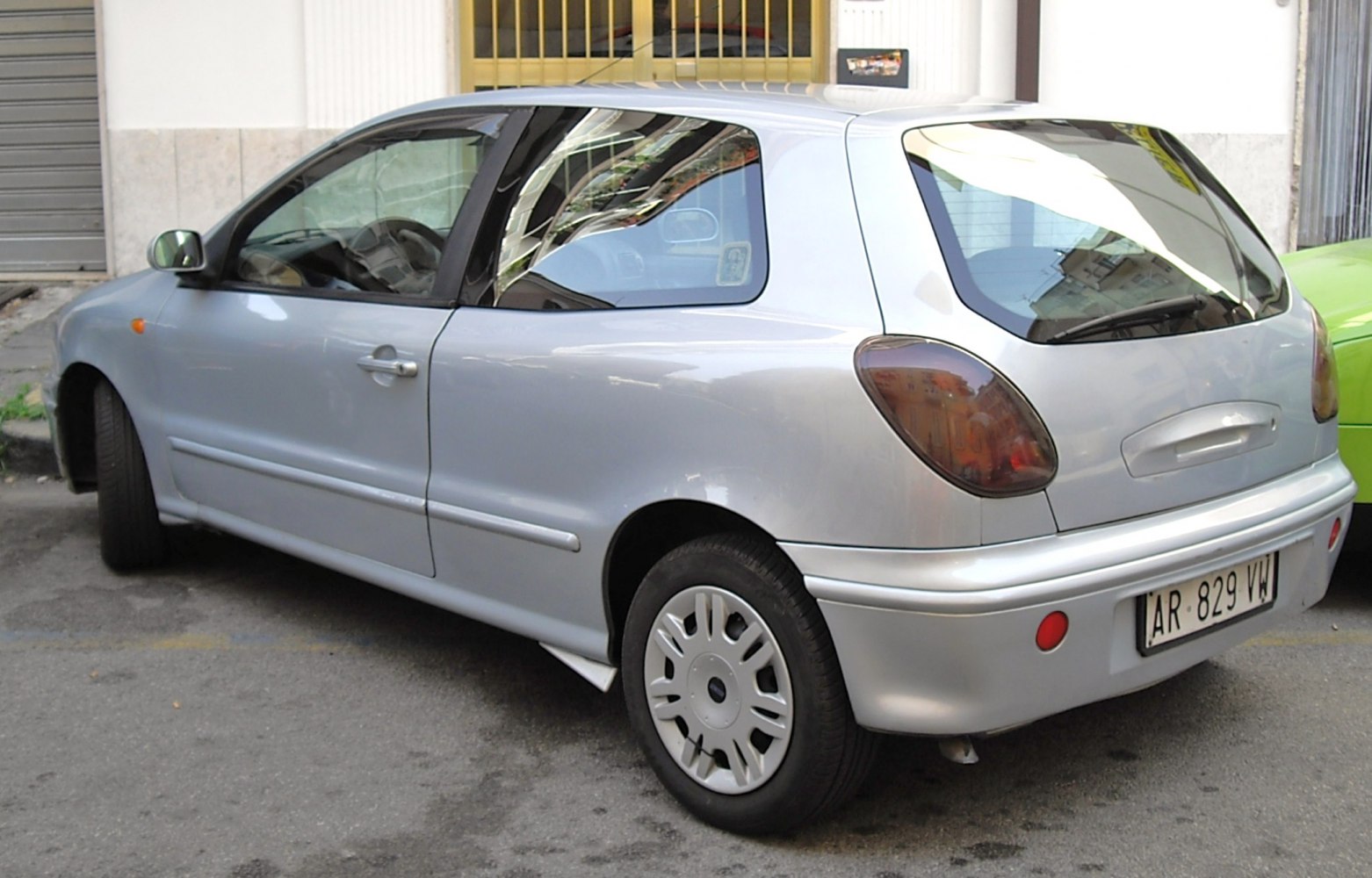 Silver compact hatchback rear side with unique taillights.