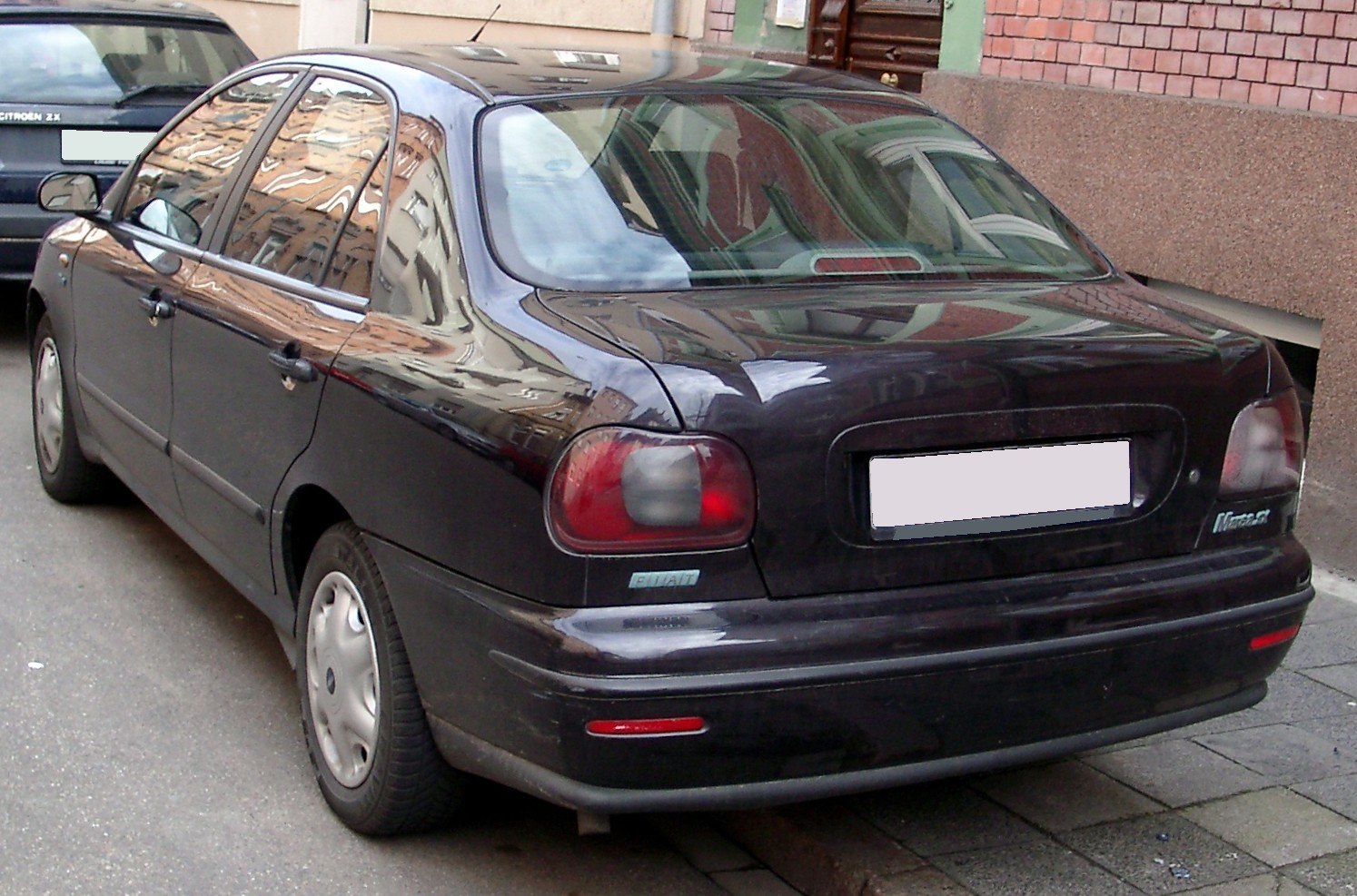 Rear view of sedan with rounded taillights and compact body