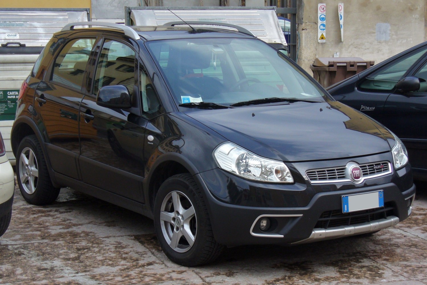 Front-side view of compact SUV with roof rails and alloy wheels