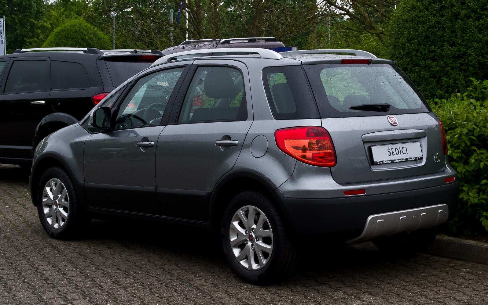 Rear and side view of a compact SUV with roof rails and taillights