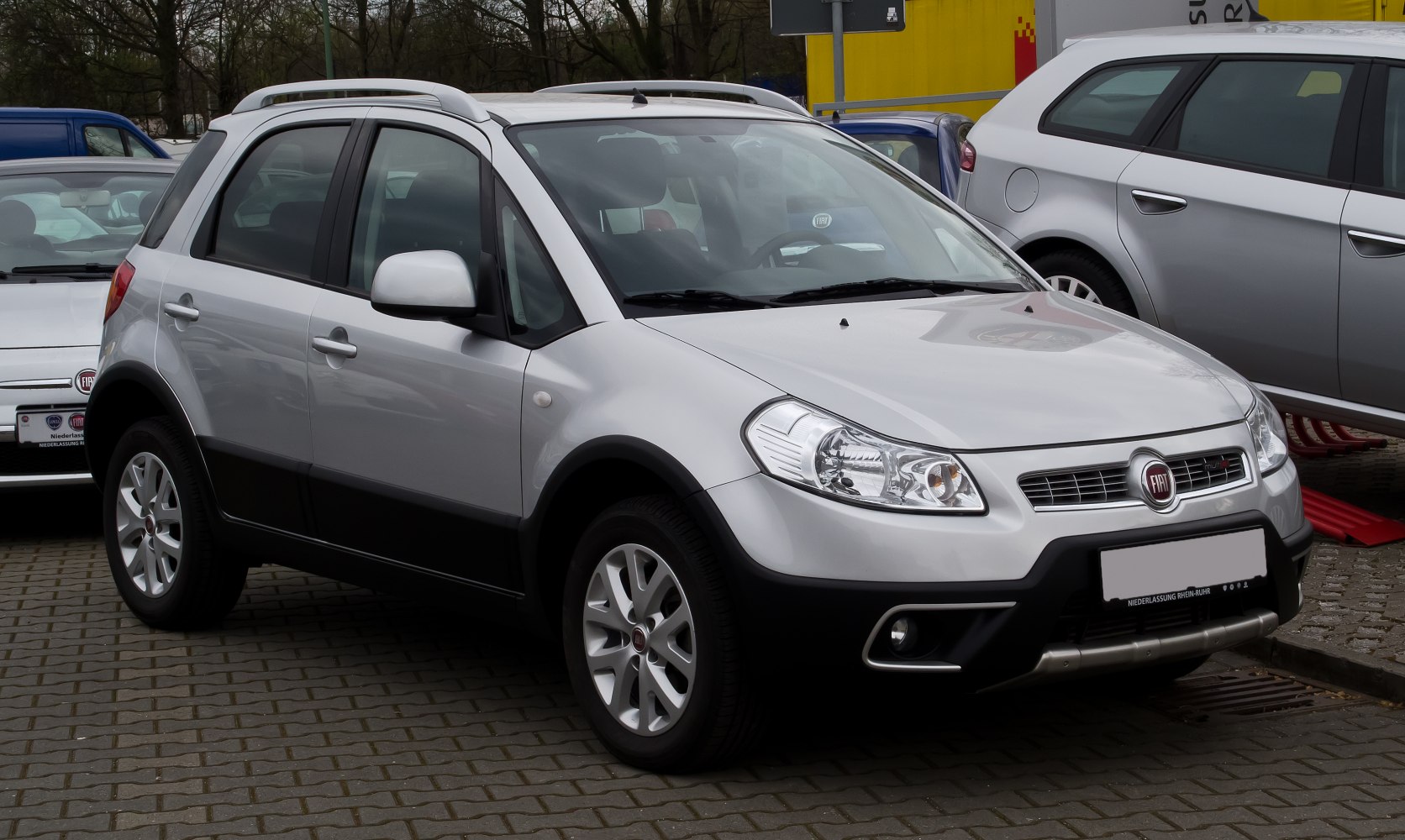 Silver compact SUV with roof rails and front fog lights