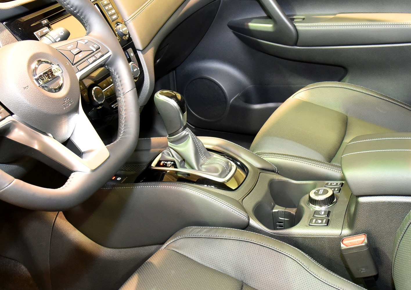 Gear shift lever and steering wheel in car interior