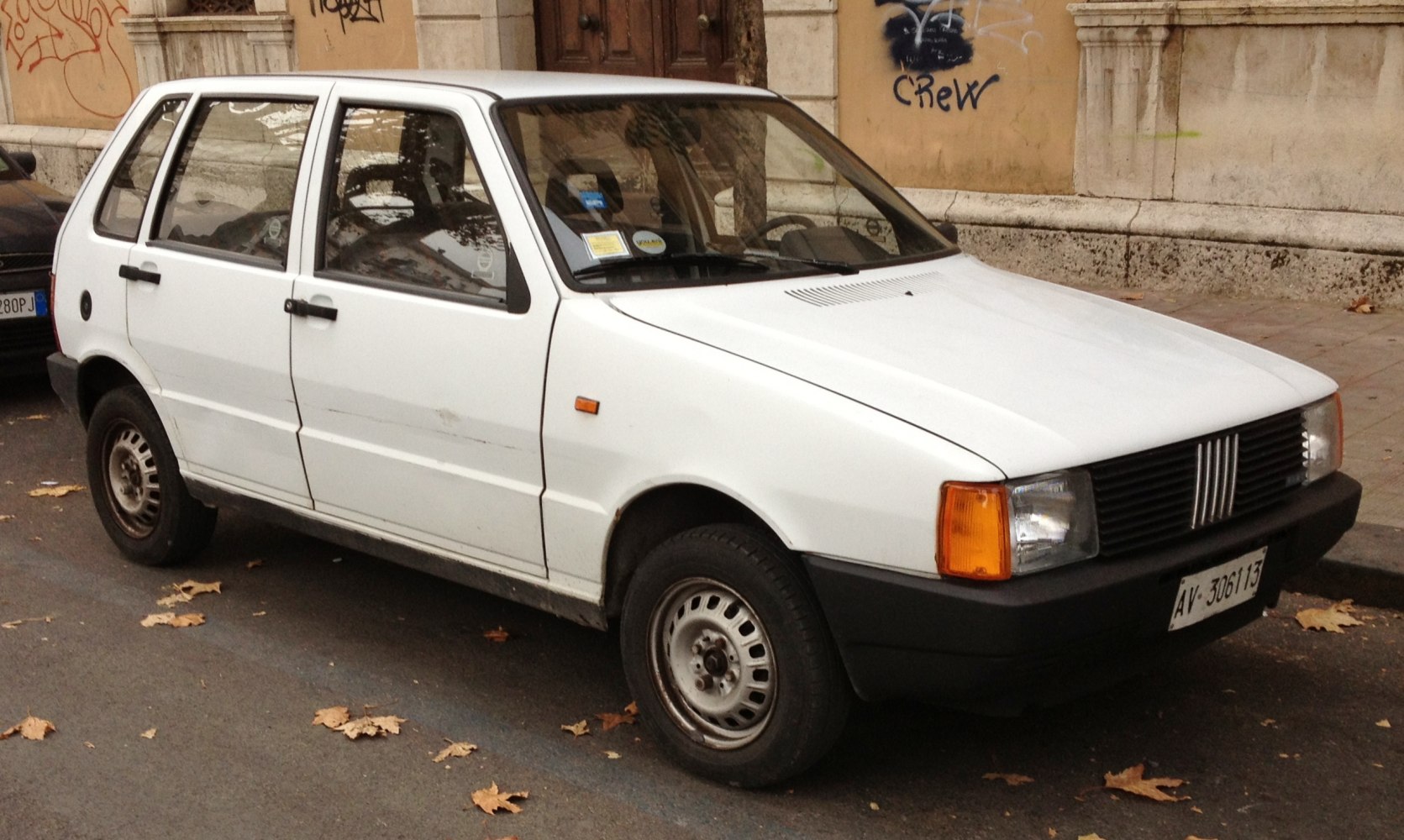 White classic hatchback with boxy front and steel wheels.