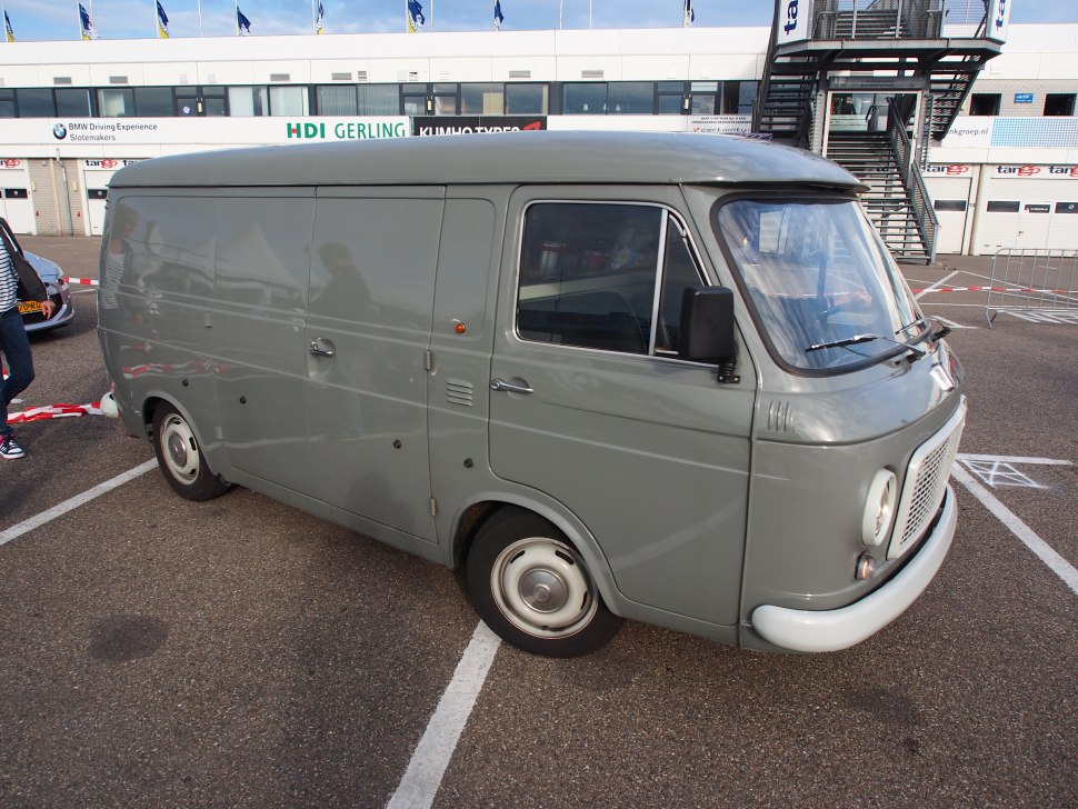 Vintage panel van with rounded front and smooth side panels.