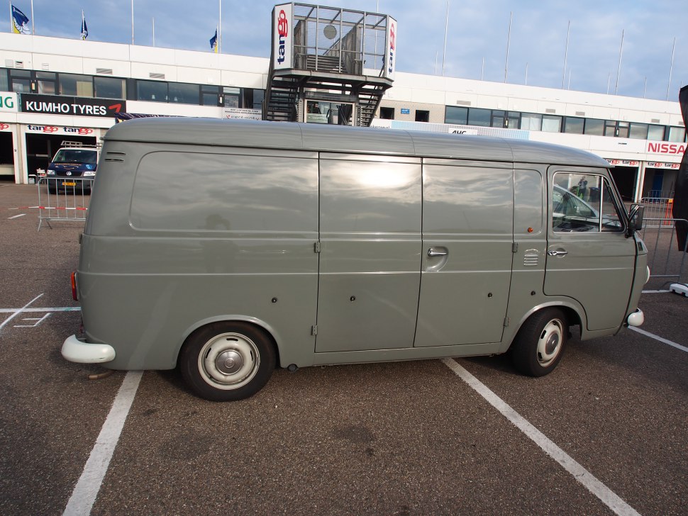 Gray vintage delivery van with sliding door and rounded body design