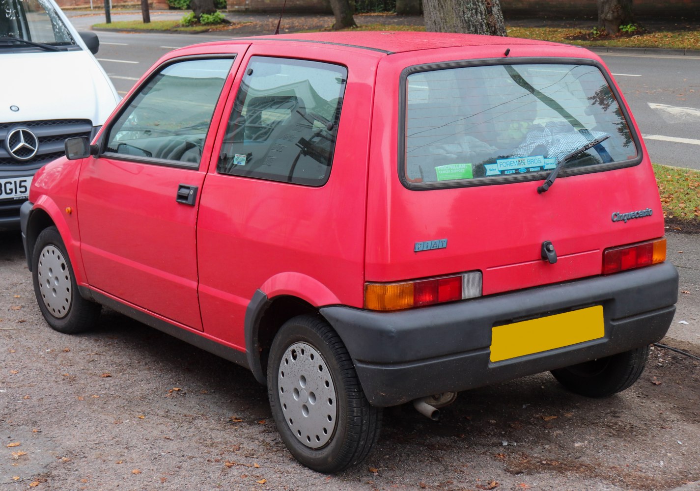 Side and rear view of a compact hatchback car with classic design elements