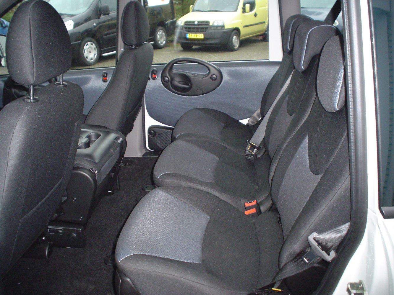 Rear seat interior with black upholstery and cup holders