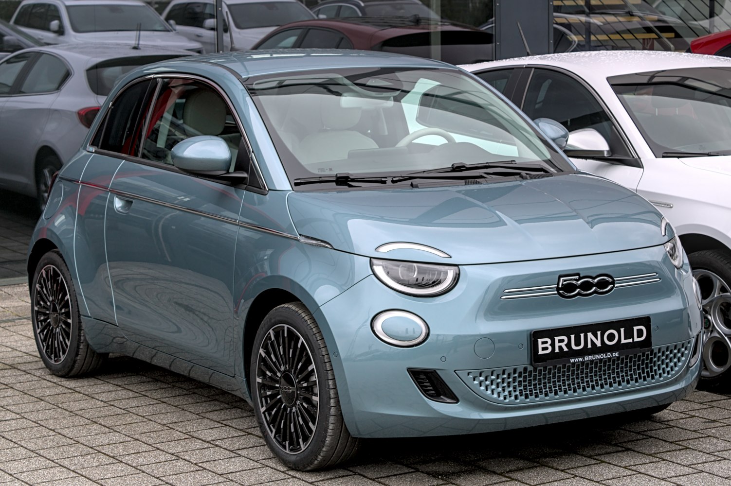 Compact electric city car with unique 3+1 door layout and modern headlights