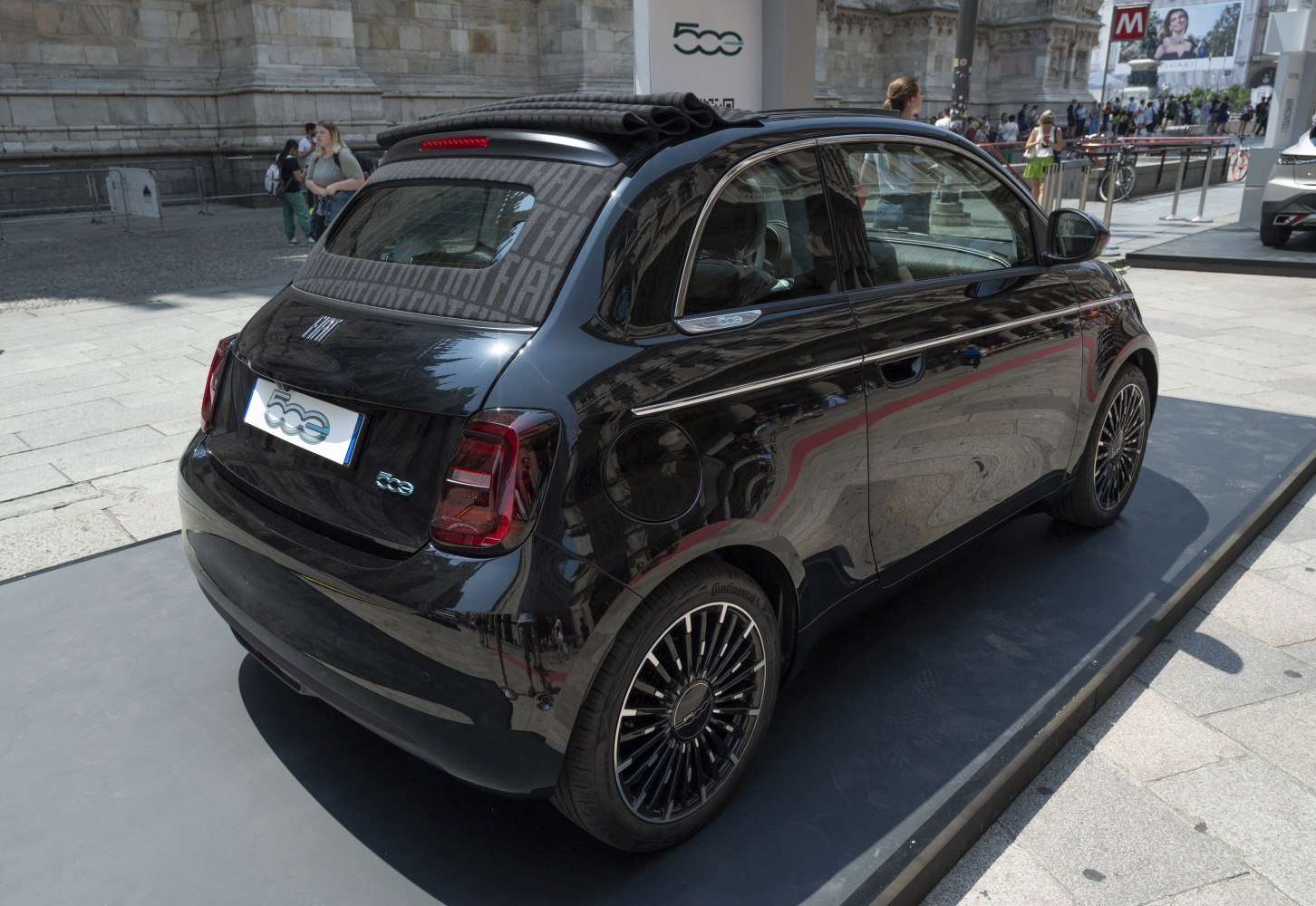 Black electric convertible with folded soft top and distinct alloy wheels