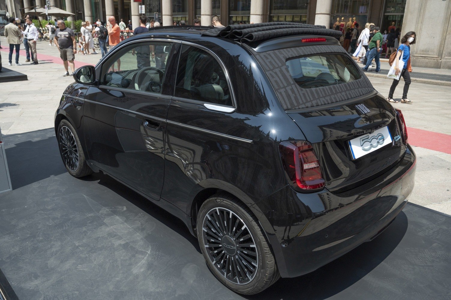 Rear view of electric convertible with soft top and distinctive alloy wheels
