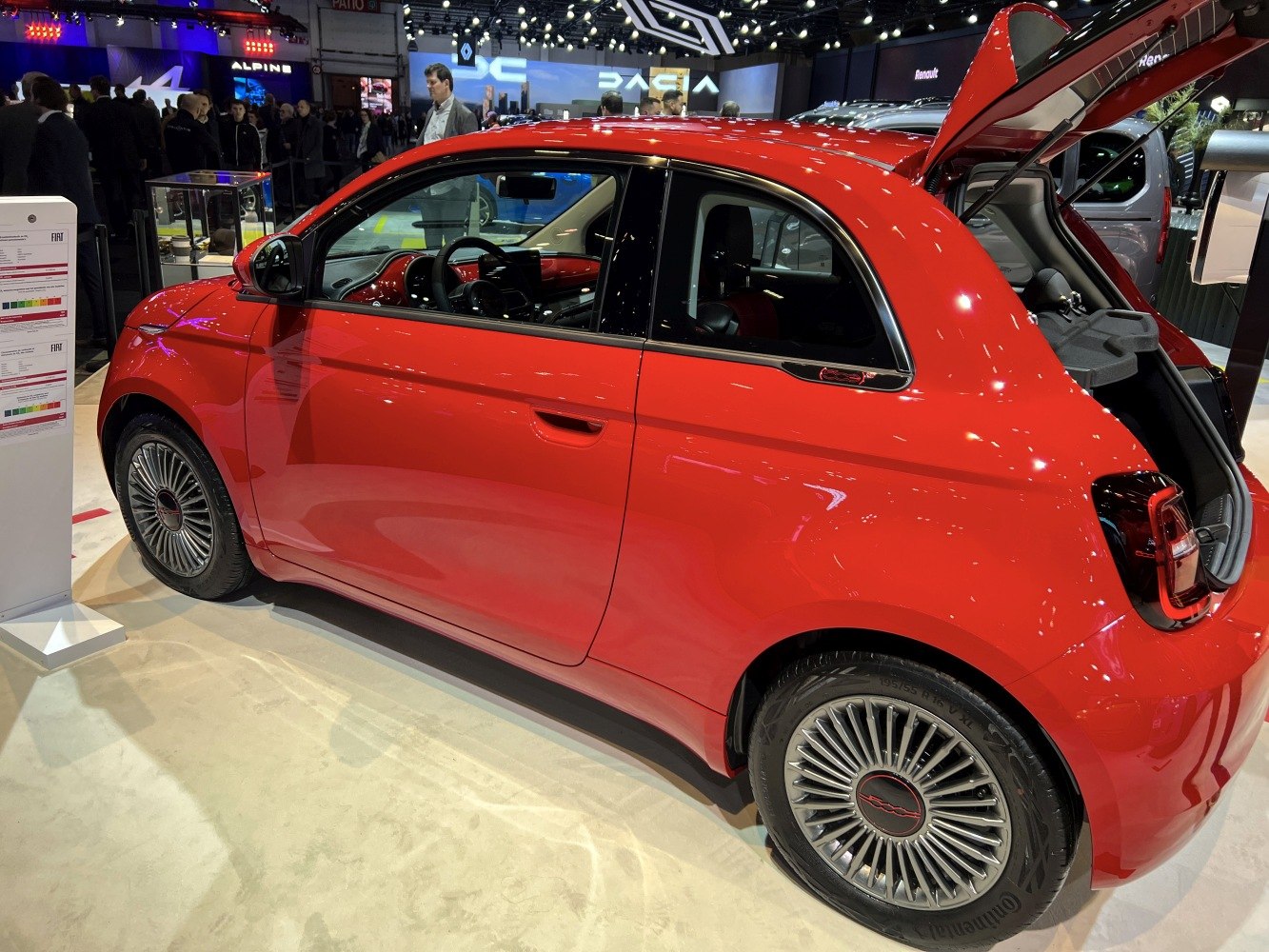 Compact electric hatchback with multi-spoke alloy wheels and rear hatch open