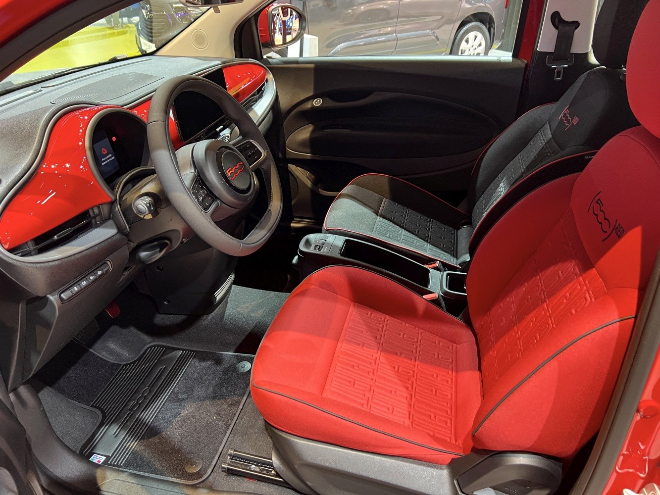 Electric car interior with red and black seats and modern dashboard